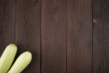 Zucchini on an old wooden table. Top view.の写真素材