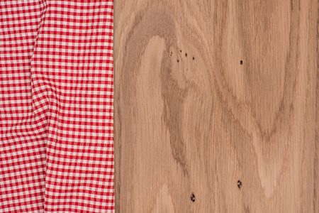 the checkered tablecloth on wooden tableの写真素材