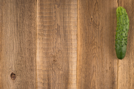 Cucumber on an old wooden tableの写真素材