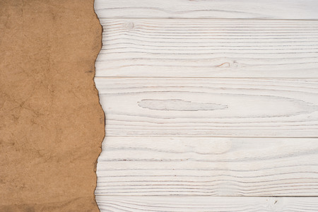 Old paper on an old white wooden table. Top view.