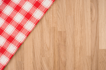 the checkered tablecloth on wooden tableの写真素材
