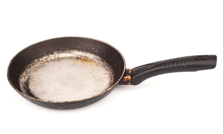 Dirty old frying pan. Isolated on white backgroundの写真素材