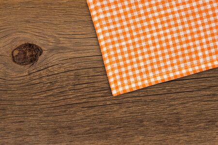 Rustic wooden boards with a orange checkered tableclothの写真素材