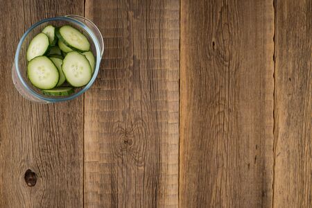 cucumber slices on wooden background. Top view.の写真素材