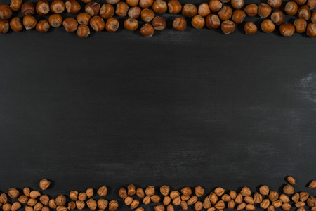 Hazelnuts  on the chalkboard. Top view.の写真素材