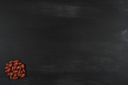 Peanuts on black chalkboard. Top view.の写真素材