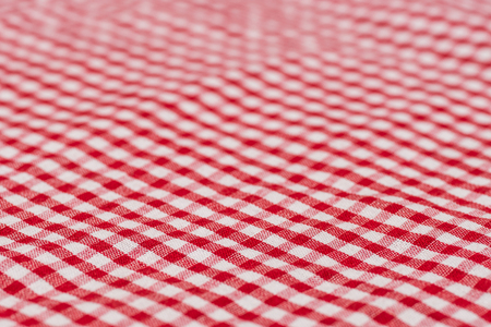 Checkered tablecloth kitchen selective focus. the white and red checkered background. Selective focus.の写真素材