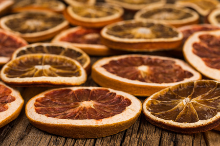 Dried oranges and grapefruits on an old wooden table. Selective focus.の写真素材