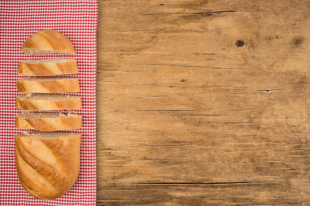 Loaf of bread on a wooden table. Top view