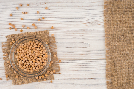 Chickpeas in a glass bowl on old wooden table. Top view.の写真素材