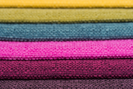 Colorful upholstery fabric samples background. Abstract background, empty template. Selective focus.の写真素材