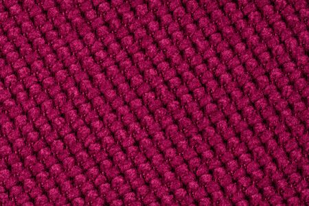 Dark red background from a textile material. Fabric with natural texture. Cloth backdrop.の写真素材