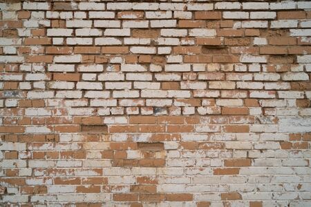 Old repaired weathered brick wall for background. Design template with place for text.
