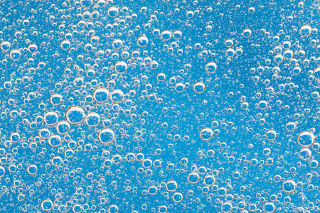 Large beautiful Oxygen bubbles underwater on a blue background macro. Movement oxygen bubbles in a...