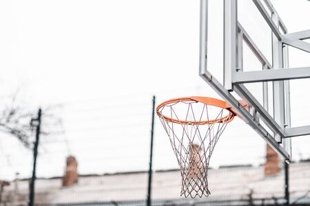A basketball orange ring at a street sports ground. bottom view. cloudy weather. macro photo. backgroungの写真素材