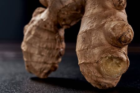 macro photo. ginger root on a black background. side view. volume ripe product. macro photo. Against viruses and diseases.の写真素材