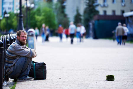 Kyiv, Ukraine, 02.05.2020: Poor man asks for money in quarantine sitting on the sidewalk. spring....