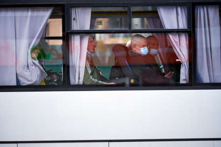 Kiev, Ukraine, 20.05.2020: People wearing medical masks are on the bus. Prohibition to walk without a mask. wait for the end of a quarantine. do not want to ache. quarantine. covid-19.のeditorial素材