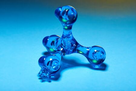 Hand massager pharaoh blue, hangs in the air against a blue background. relaxation and health....