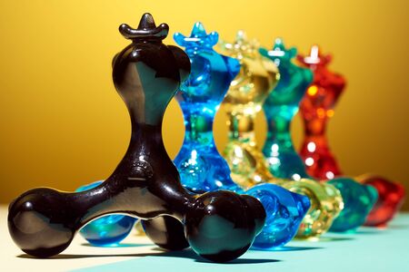 Five hand masseurs called pharaoh, of different colors, stand in one row, behind each other, on a yellow bright background. For relaxation and health. Thematic and subject photography.の写真素材