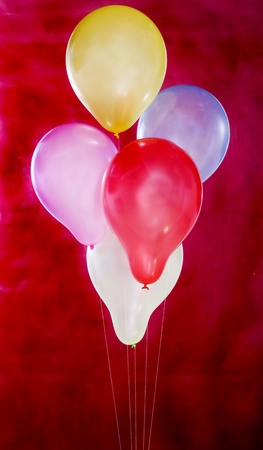 Party balloons on a red background の写真素材