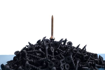 Black and brass angled screws isolated on whiteの写真素材