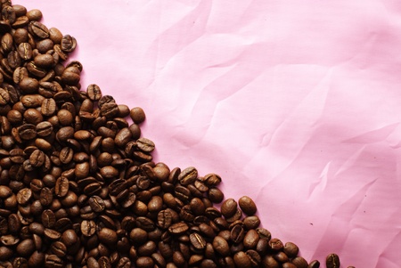 coffee beans on pink silkの写真素材