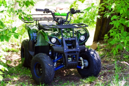 camouflage ATV 125 cc  parked in forestのeditorial素材
