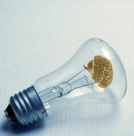 old bulb with brain on white paperの写真素材