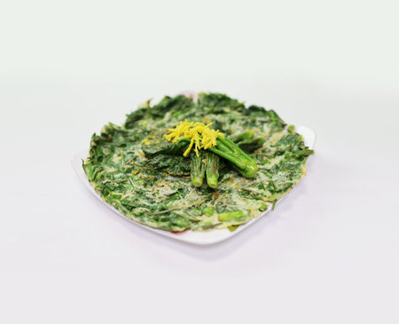 Spinach pancakes with dill and yellow flower on white backgroundの写真素材