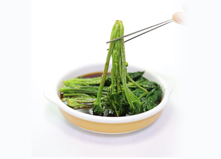 stir-fried water spinach with chopsticks isolated on white backgroundの写真素材