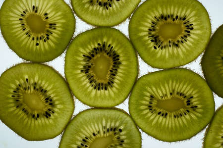 Kiwi fruit sliced and phographed on a light tableの写真素材