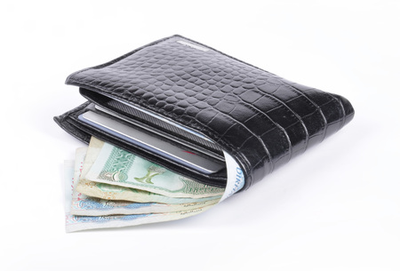 black leather wallet with money isolated on white background の写真素材