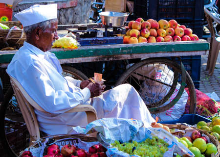 The old fruit  seller count daily incomeのeditorial素材