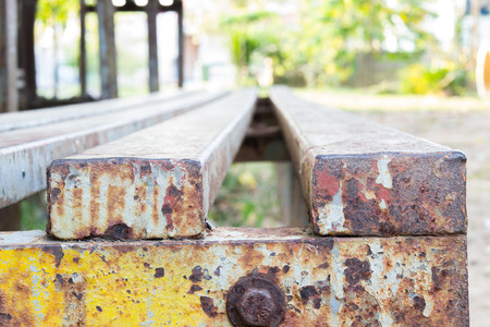 An old rusty metal stairs beside a playground.の写真素材