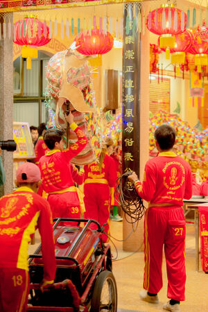 Acrobats are performing a lion and dragon dance with a well trained skill, danger but very exciting on February 12, 2014 in Yala, Thailand.のeditorial素材
