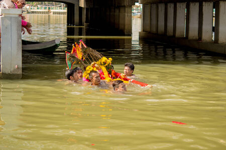 A chinese goddess palanquins are carried across the river by people that have faith on February 14, 2014 in Pattani, Thailand.のeditorial素材
