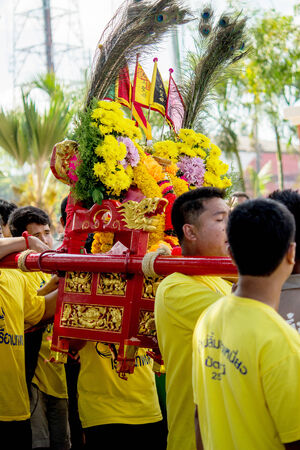 Many people are celebrate chinese gods by carry the palanquin to cross over a river an step into fire on February 14, 2014 in Pattani, Thailand.のeditorial素材
