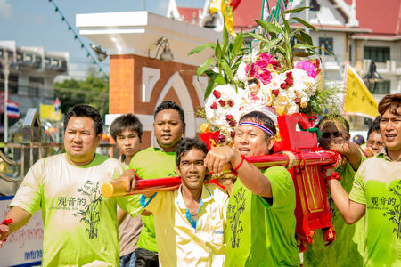 Many people are celebrate chinese gods by carry the palanquin to cross over a river an step into fire on February 14, 2014 in Pattani, Thailand.のeditorial素材