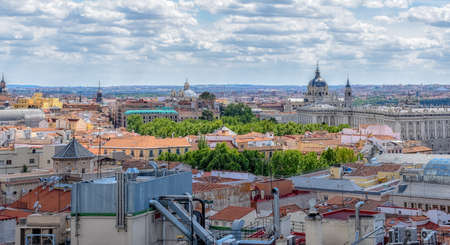 View of the buildings of the city on a sunny day. Real Palace at the bottom. Madrid, Spain
