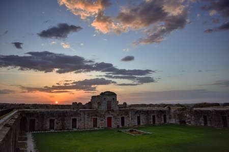 Colorful sunset landscape in old military fort ruins.の写真素材