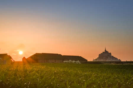 Silhouette at sunset from the farmland of Mont Saint Michel, Franceの写真素材