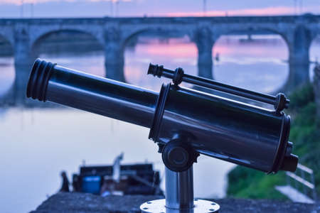 Spyglass in the foreground, and bridge at sunset background.の写真素材