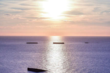 Calm sea with sunset sky. Colorful horizon over the water and Atlantic wall. Normandy, France.の写真素材