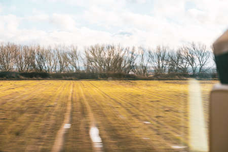 Melancholic concept of travel in autumn by train. View from the window.の写真素材