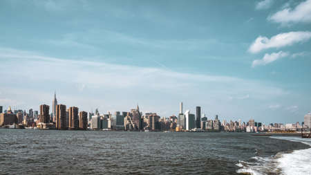 Office buildings and apartments on the skyline at sunset, from Hudson river. Real estate and travel concept. Manhattan, New York City, USA.の写真素材