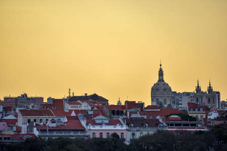 Lisbon skyline view. Colorful walls of the buildings of Lisbon, with orange roofs and the BasÃ­lica da Estrela at sunset. Travel and real estate concept. Lisbon, Portugal. Europe.の写真素材