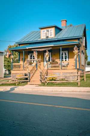 Typical country porched house in orange and blue. Canada. Rural life concept.の写真素材
