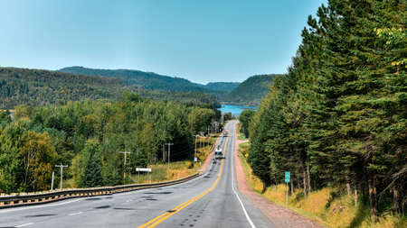 Road between forests and lakes of the Canadian state of Quebec.の写真素材