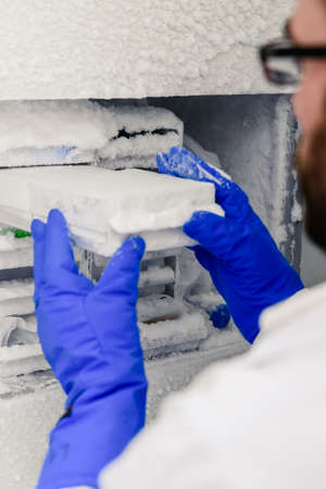 Scientific manipulating tests in bioscience laboratory freezer. Concept of science, laboratory and...